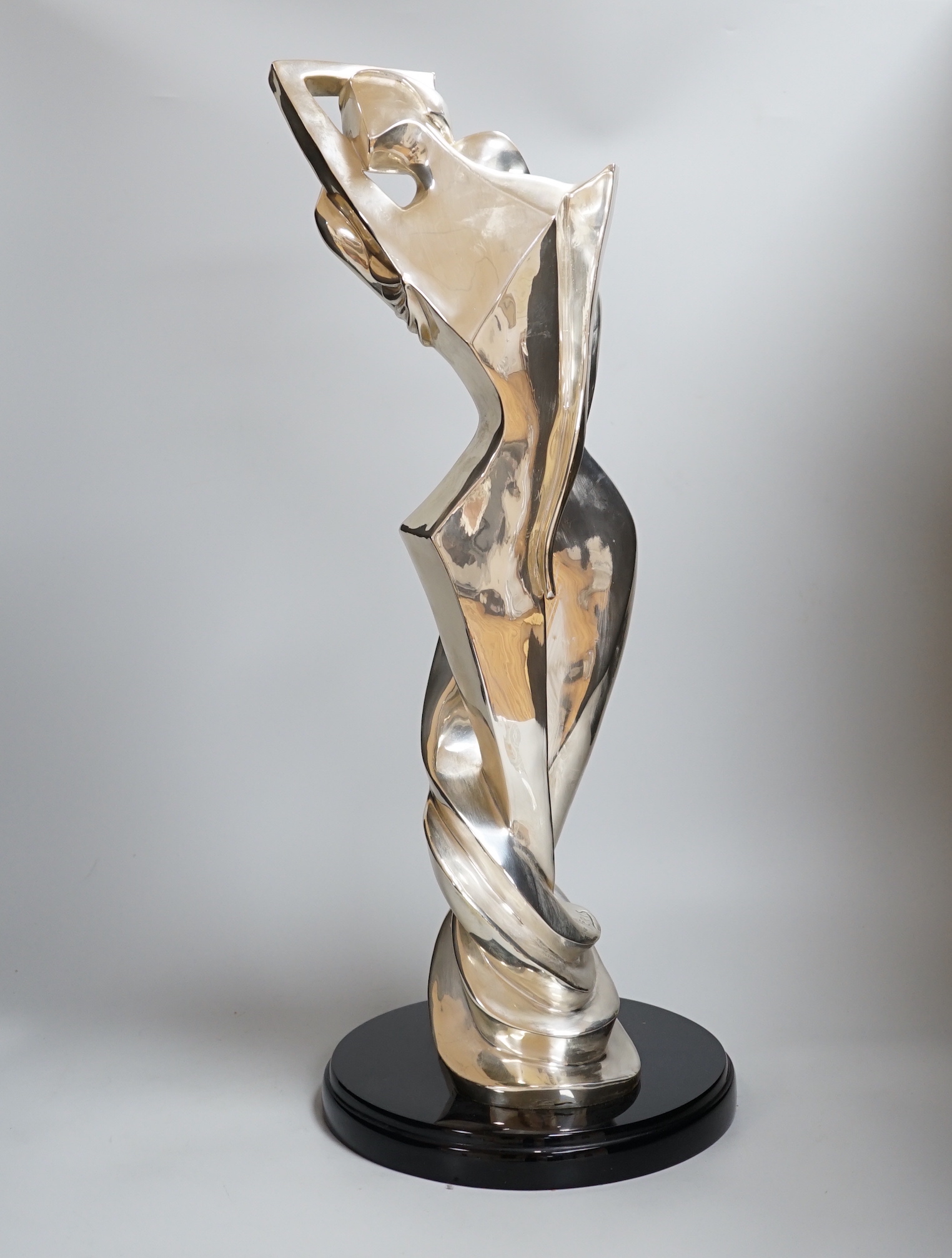 A plated abstract figural sculpture on stand, signed Geris, 45/500, 59cm